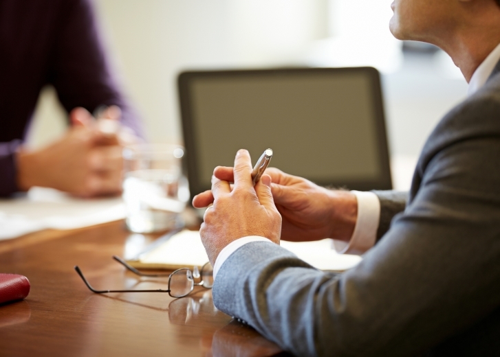 hands on a conference table